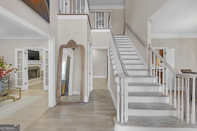 a view of an entryway with wooden floor and a livingroom view