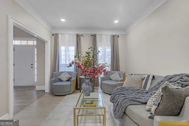 a living room with furniture and flowers