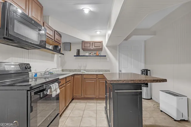 a kitchen with stainless steel appliances granite countertop a sink stove and cabinets