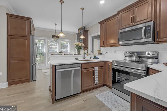 a kitchen with a sink stainless steel appliances and cabinets