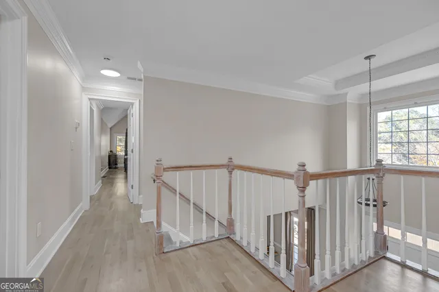 a view of hallway with wooden floor