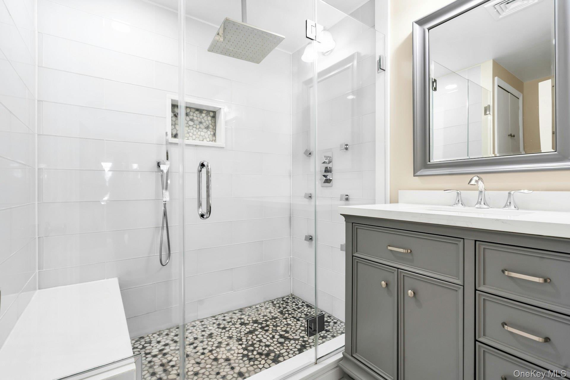 2043 Ripley Lane Merrick, NY 11566 - Photo 30 of 42 a bathroom with a sink a toilet a shower and a mirror