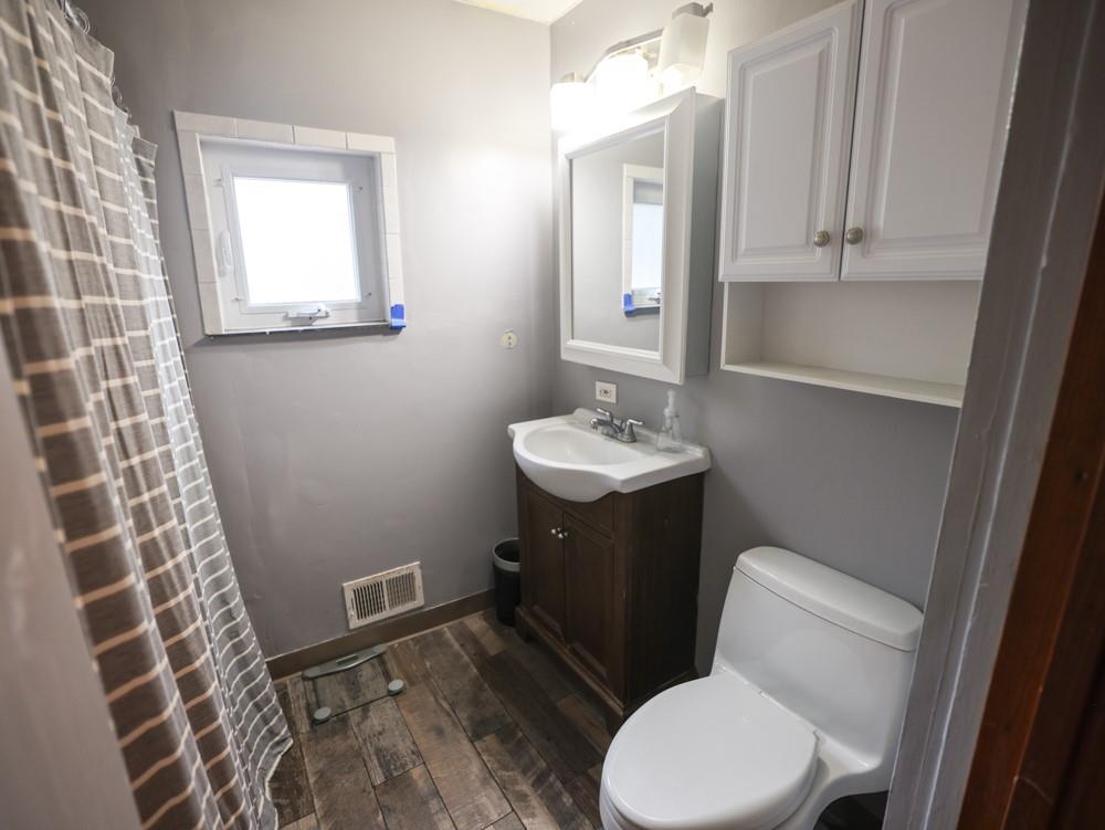 1728 Chislett Street Pittsburgh, PA 15206 - Photo 13 of 16 a bathroom with a toilet a sink and mirror