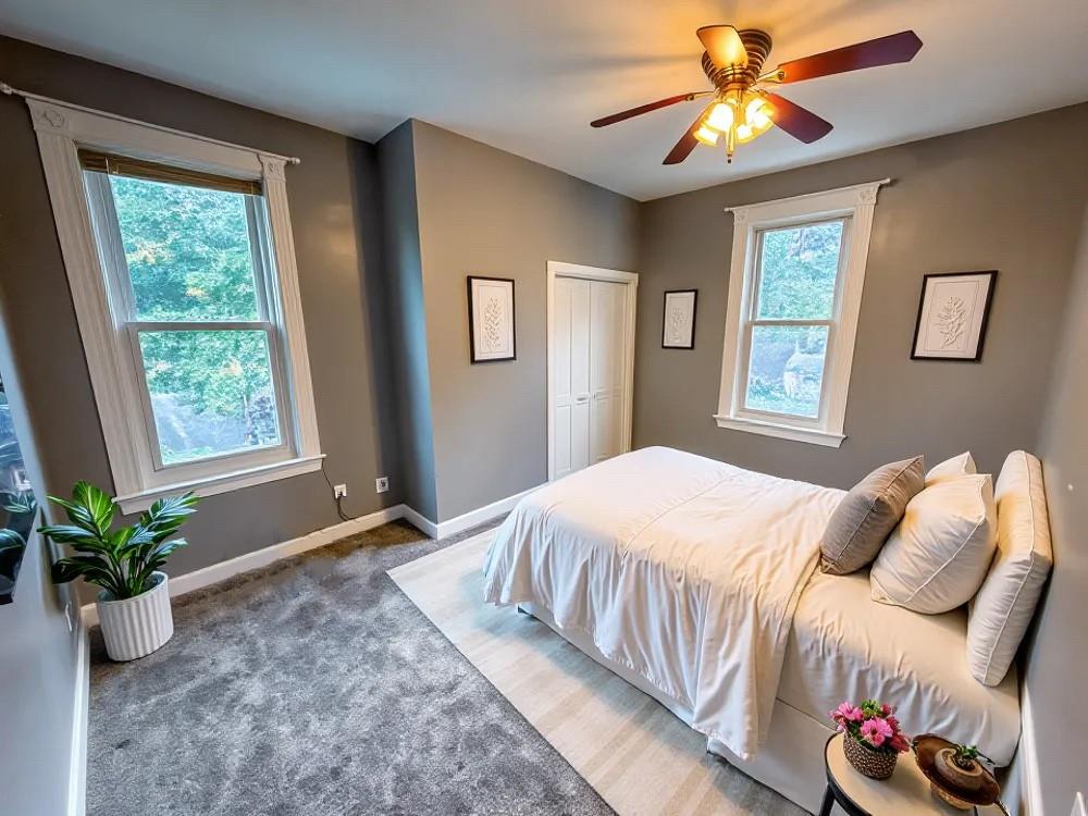 1728 Chislett Street Pittsburgh, PA 15206 - Photo 7 of 16 a bedroom with a bed and a chandelier