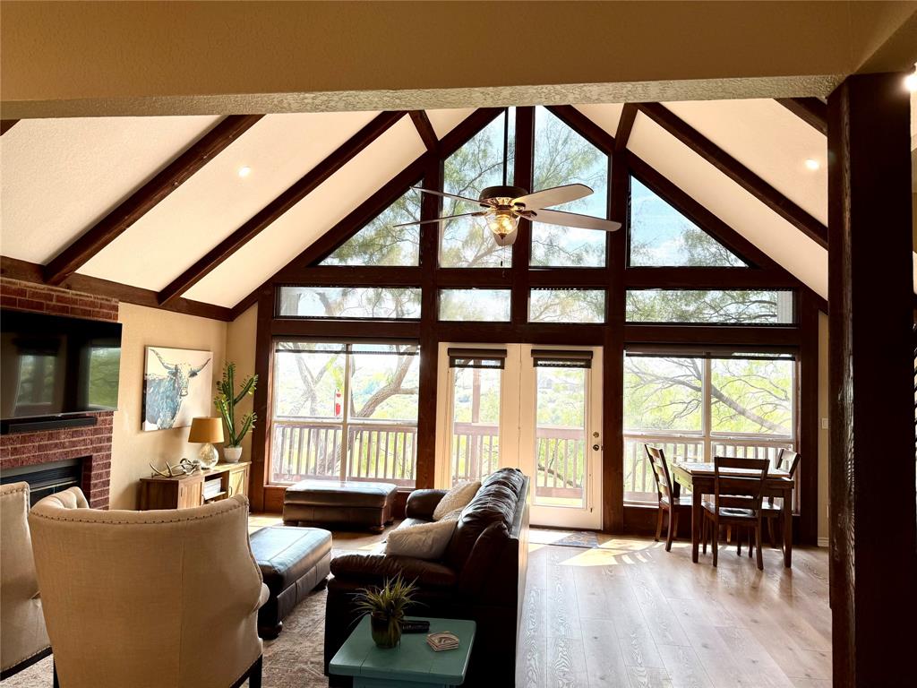 105 Turnberry Loop Graford, TX 76449 - Photo 12 of 34 a living room with furniture and a floor to ceiling windows