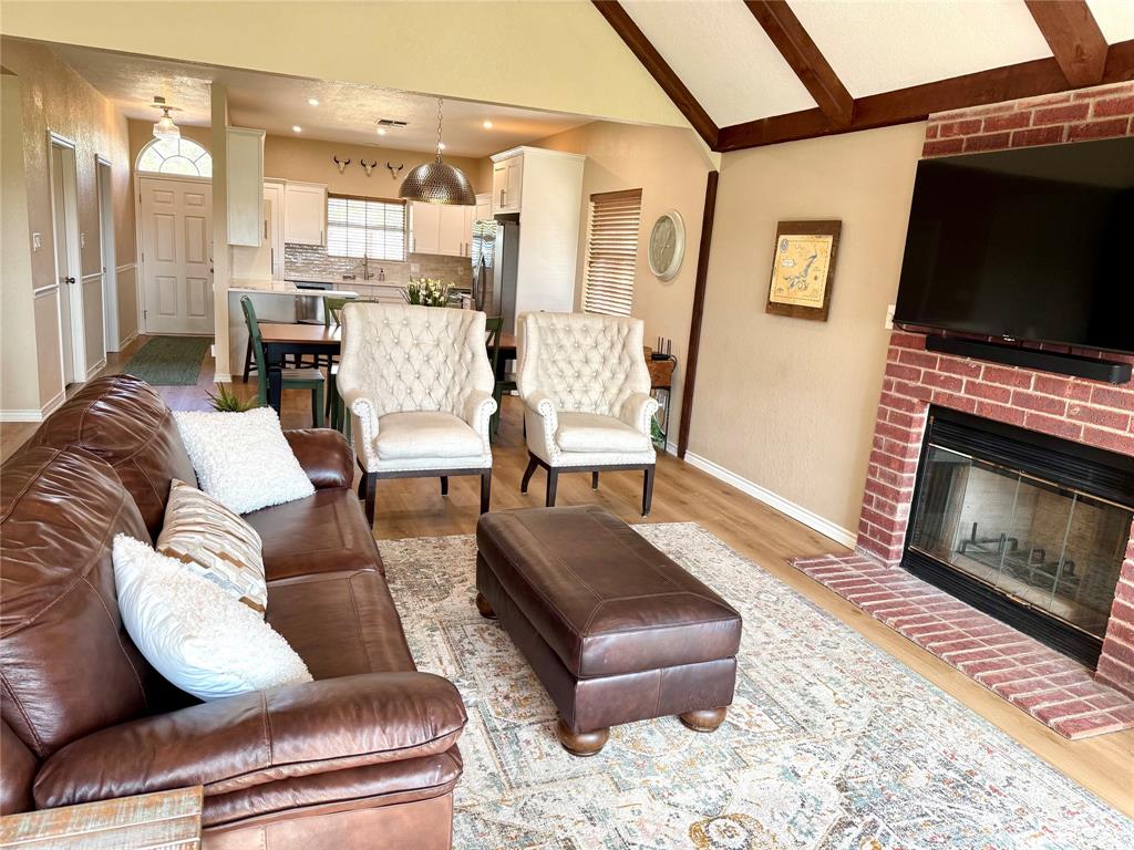 105 Turnberry Loop Graford, TX 76449 - Photo 13 of 34 a living room with furniture or outdoor view and a fireplace