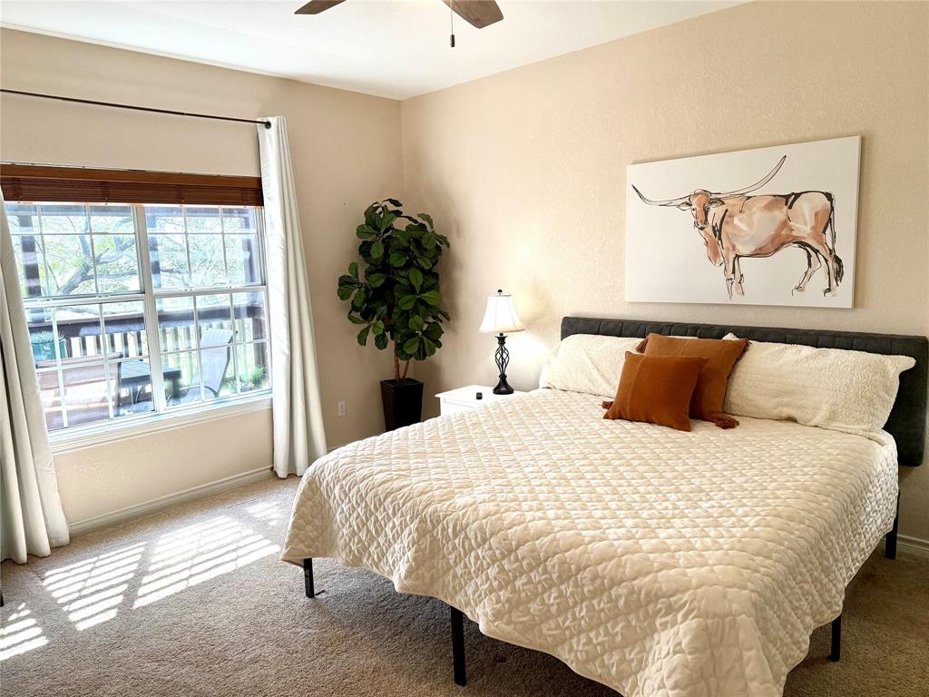 105 Turnberry Loop Graford, TX 76449 - Photo 19 of 34 a large bed sitting in a bedroom next to a window