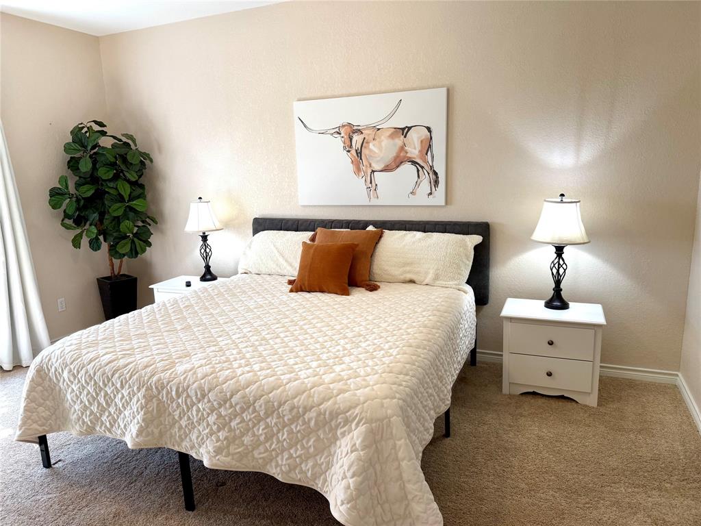 105 Turnberry Loop Graford, TX 76449 - Photo 20 of 34 a bedroom with a bed and a painting on the wall