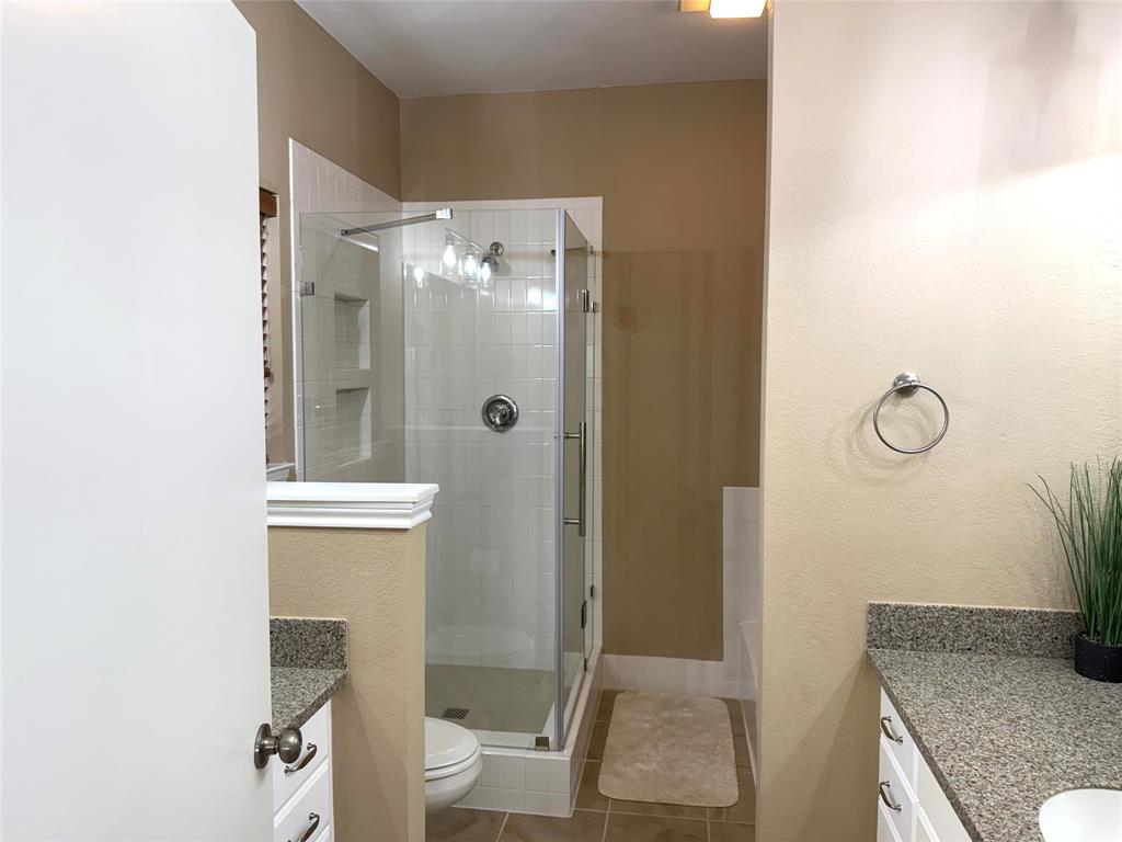105 Turnberry Loop Graford, TX 76449 - Photo 22 of 34 a bathroom with a granite countertop shower a toilet and a sink