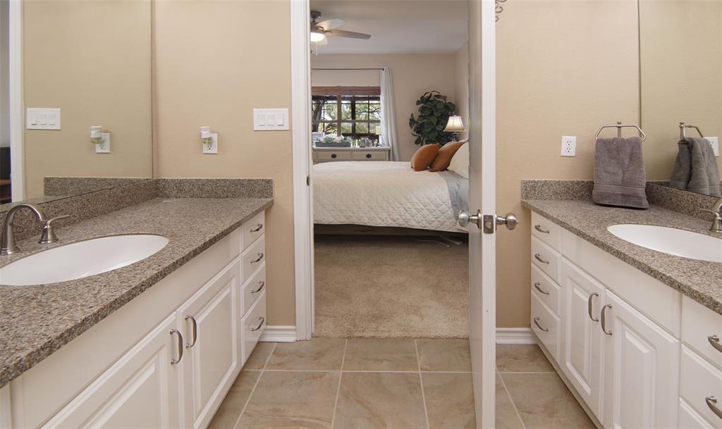 105 Turnberry Loop Graford, TX 76449 - Photo 23 of 34 a en suite bathroom with a granite countertop sink and a vanity