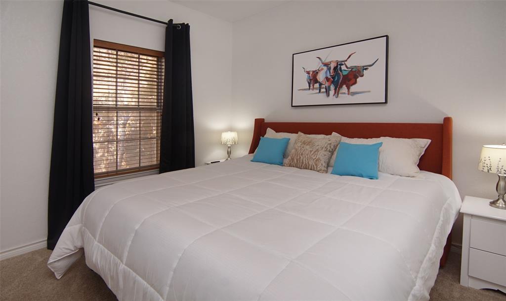 105 Turnberry Loop Graford, TX 76449 - Photo 26 of 34 a large bed sitting in a bedroom next to a window