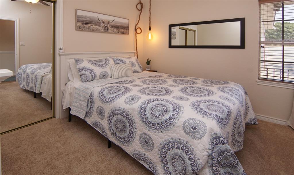 105 Turnberry Loop Graford, TX 76449 - Photo 27 of 34 a bedroom with a bed and a window