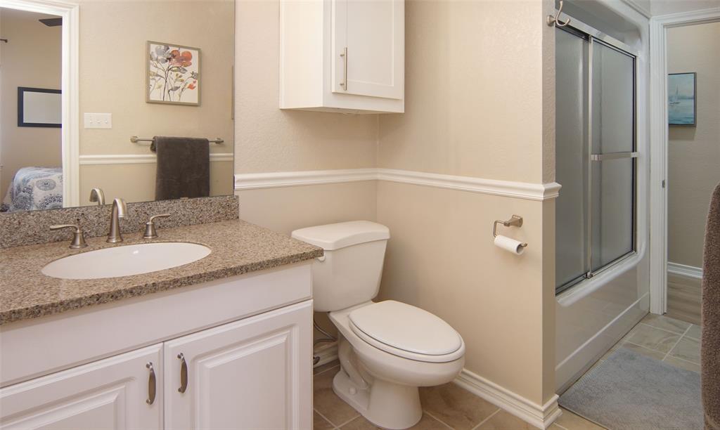 105 Turnberry Loop Graford, TX 76449 - Photo 28 of 34 a bathroom with a granite countertop toilet sink and mirror