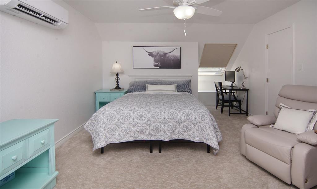 105 Turnberry Loop Graford, TX 76449 - Photo 32 of 34 a bedroom with a bed and a chandelier