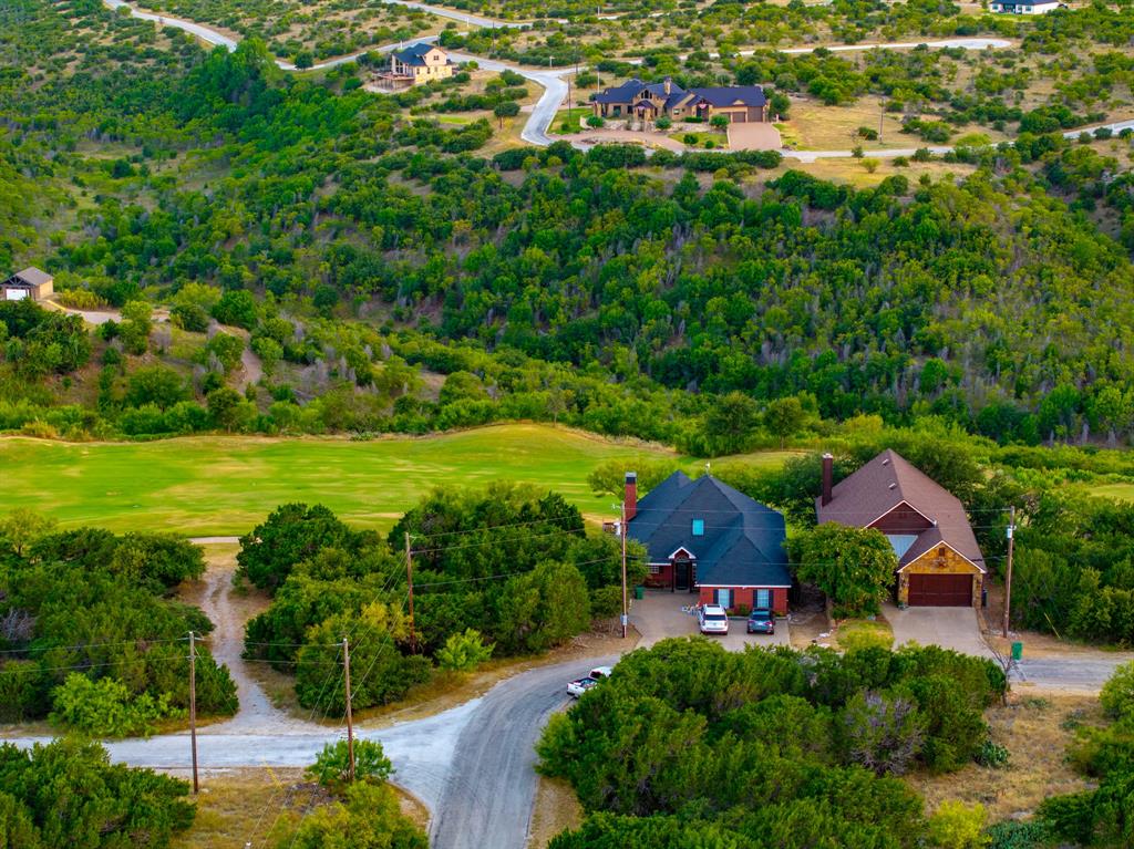 105 Turnberry Loop Graford, TX 76449 - Photo 5 of 34 an aerial view of residential houses with outdoor space and trees