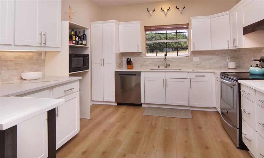 105 Turnberry Loop Graford, TX 76449 - Photo 9 of 34 a kitchen with a sink stove and cabinets