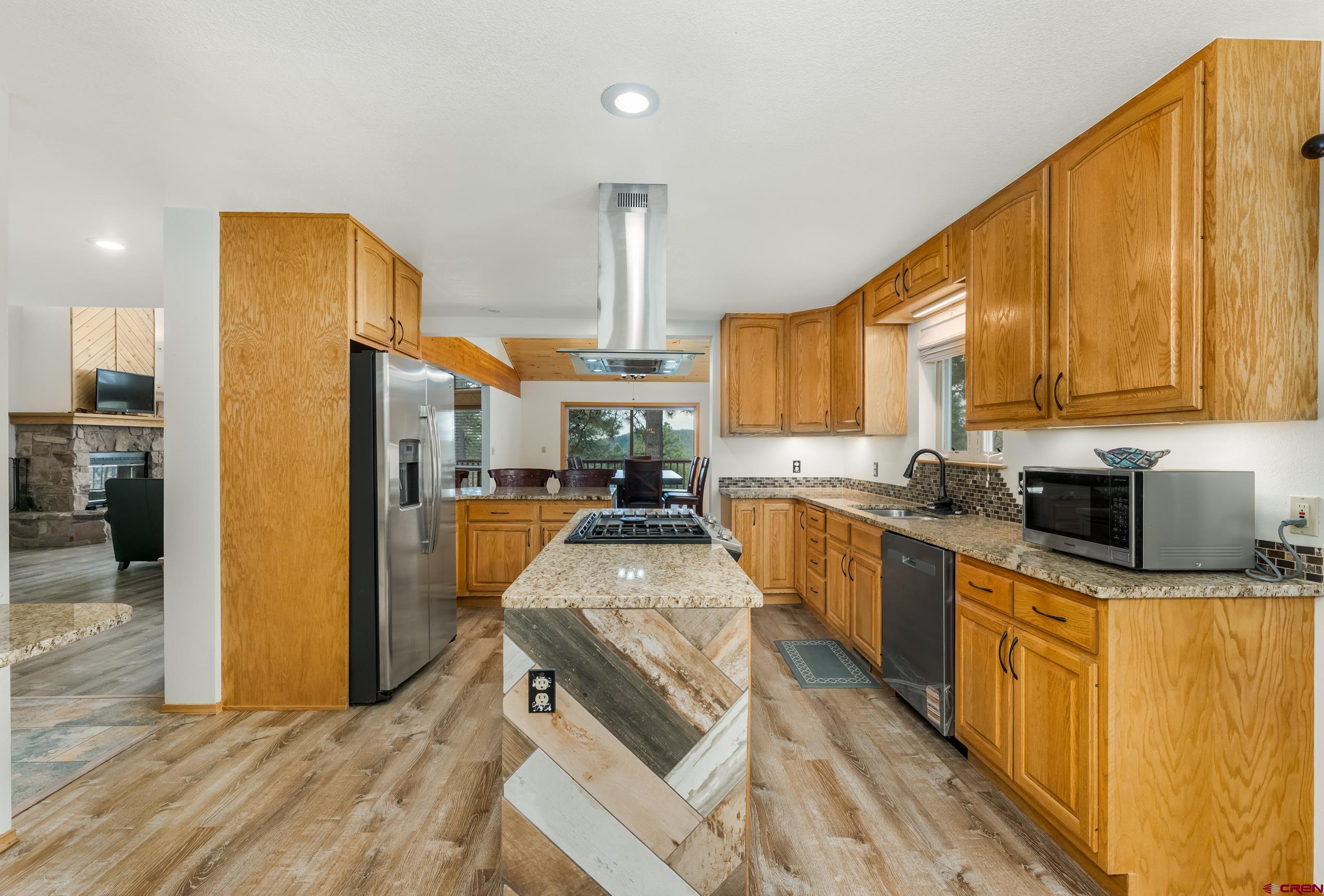 197 Buckhorn Road Bayfield, CO 81122 - Photo 14 of 34 a kitchen with stainless steel appliances granite countertop a refrigerator a stove top oven and a sink