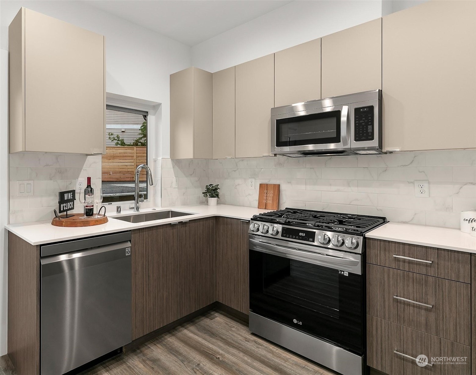 10146 Holman Road Northwest Seattle, WA 98133 - Photo 7 of 24 a kitchen with stainless steel appliances a sink a stove and microwave