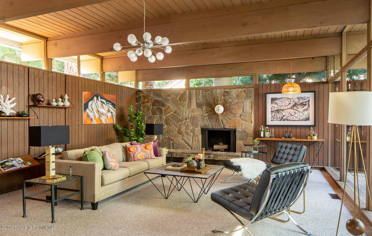 300 Anita Drive Pasadena, CA 91105 - Photo 4 of 28 a living room with furniture a chandelier and a flat screen tv
