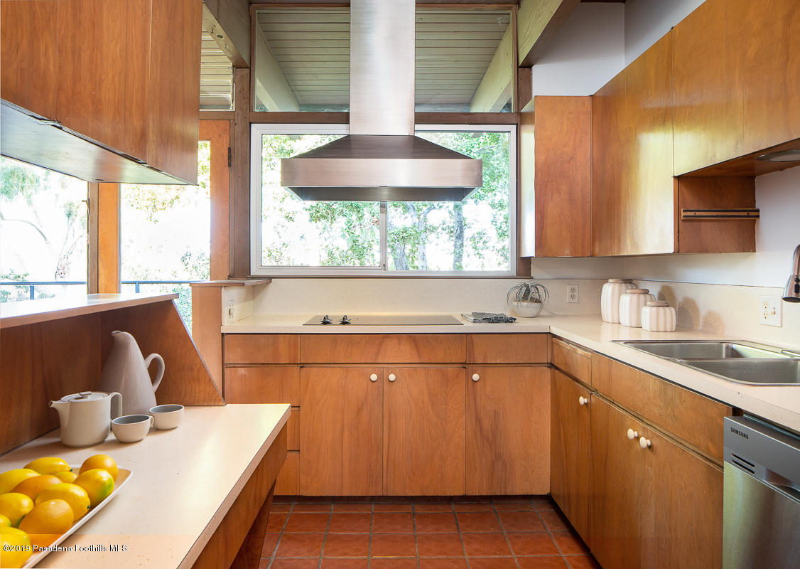 300 Anita Drive Pasadena, CA 91105 - Photo 10 of 28 a kitchen with a sink stove and cabinets