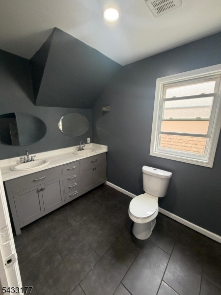 166 Renner Avenue, Unit 3 Newark, NJ 07112 - Photo 14 of 24 a bathroom with a toilet sink and a mirror