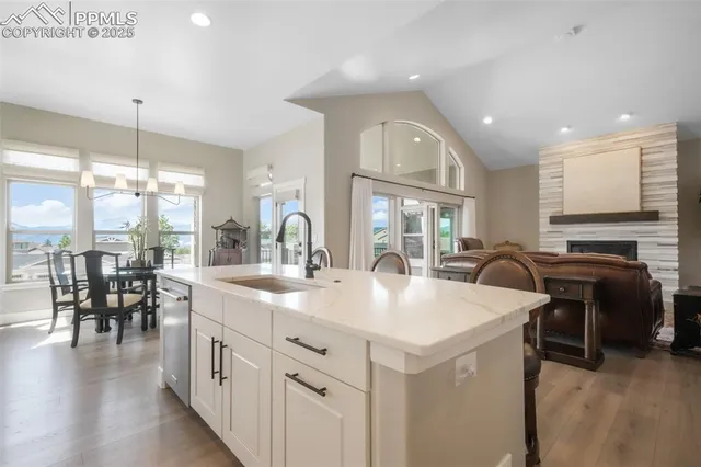 a kitchen with sink table and chairs