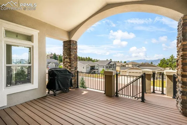 a view of a balcony with furniture and wooden floor