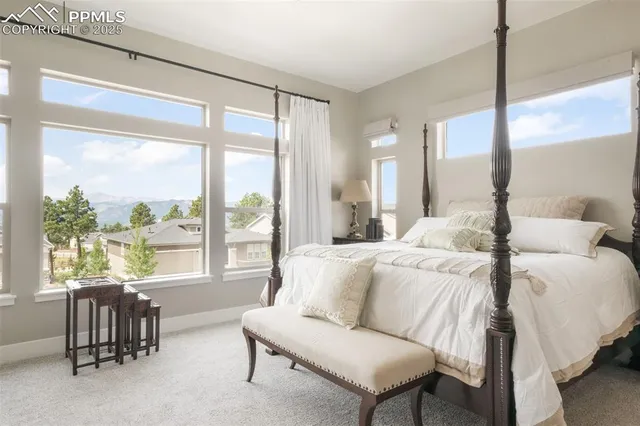 a spacious bedroom with a bed and a large window