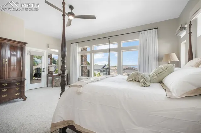 a large bedroom with a large bed and glass door