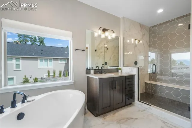 a bathroom with a tub sink and mirror
