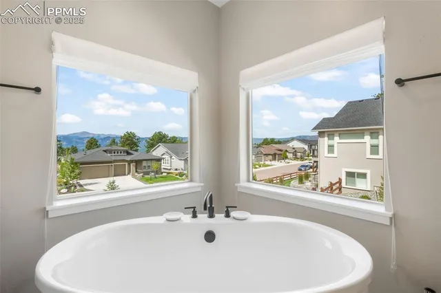 a white bath tub sitting next to a window