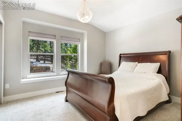 a bedroom with a bed and a window with outer view