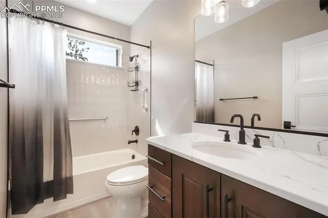 a bathroom with a granite countertop toilet sink and shower