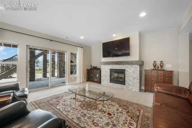 a living room with furniture a flat screen tv and a fireplace