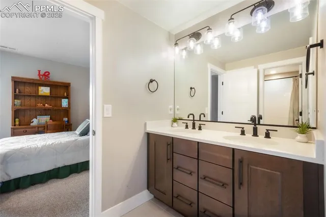 a bathroom with a double vanity sink and mirror