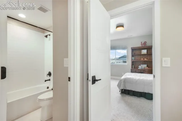 a bathroom with a tub and a toilet