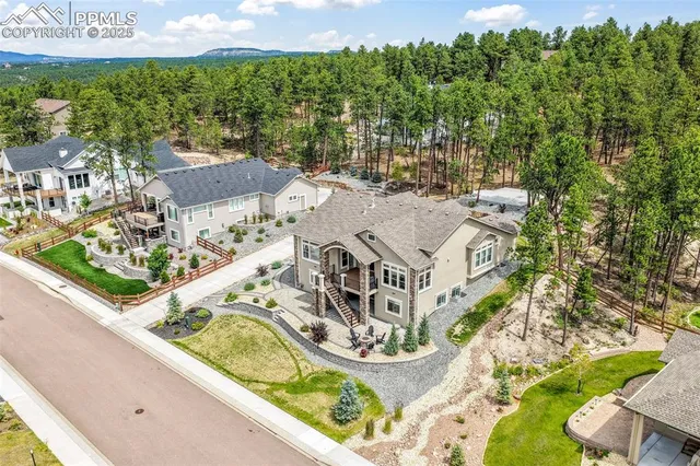 an aerial view of residential house with outdoor space and swimming pool