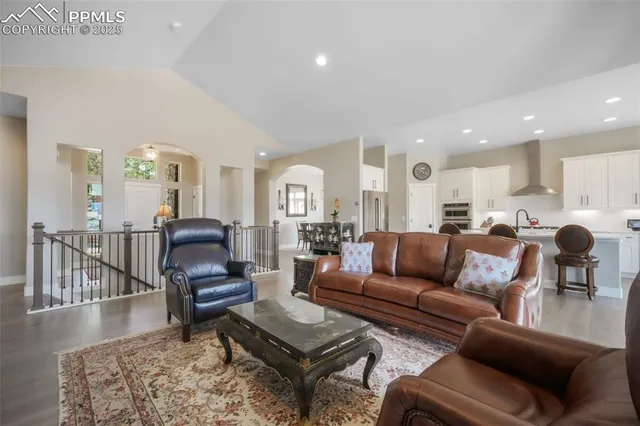 a living room with furniture or kitchen view and a wooden floor