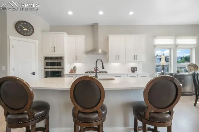 a kitchen with kitchen island a stove and a stove