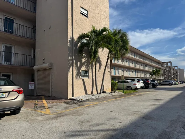 a couple of cars parked in front of a building