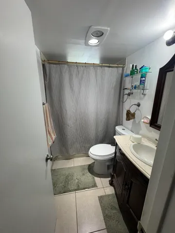 a bathroom with a toilet a sink and shower