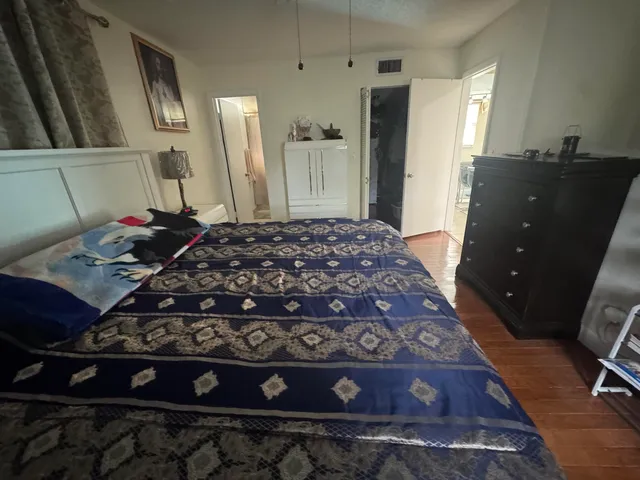 a bed sitting in a room next to a window