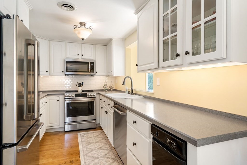 14 Highview Drive Hingham, MA 02043 - Photo 17 of 41 a kitchen with stainless steel appliances granite countertop a sink a stove a refrigerator cabinets and a window