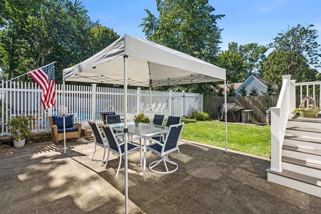 14 Highview Drive Hingham, MA 02043 - Photo 30 of 41 a view of a patio with table and chairs under an umbrella