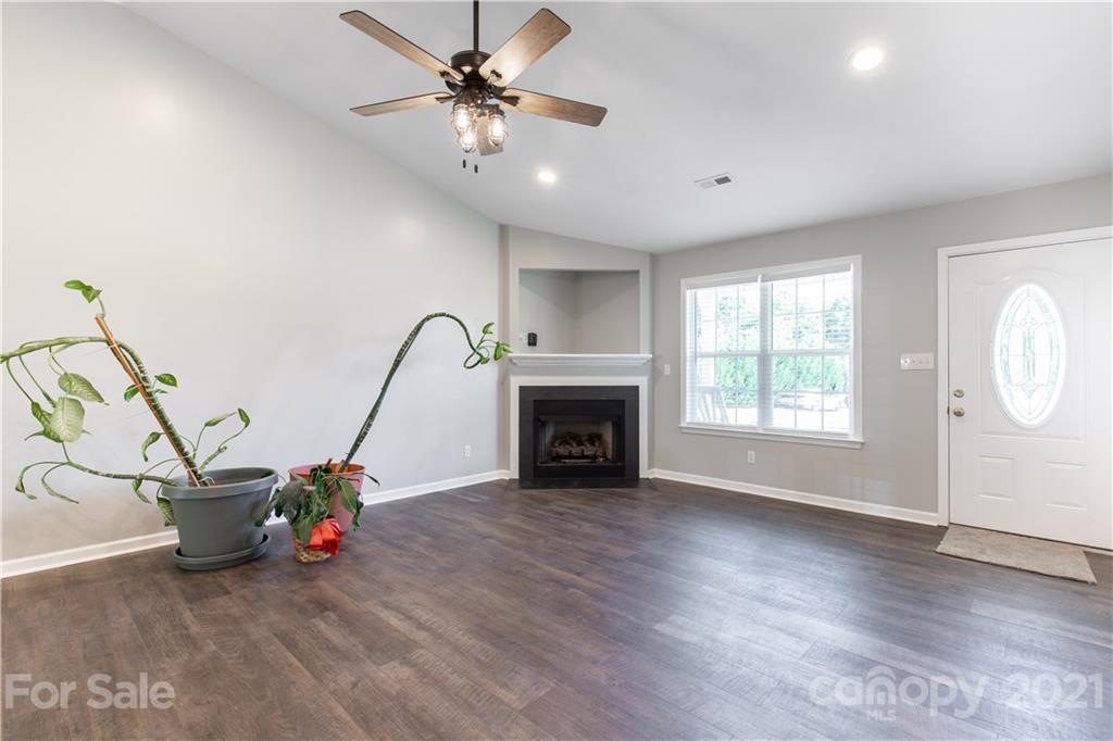 5150 Taxahaw Road Lancaster, SC 29720 - Photo 14 of 27 a view of a livingroom with a fireplace and wooden floor