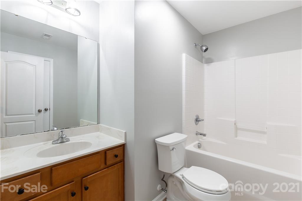 5150 Taxahaw Road Lancaster, SC 29720 - Photo 16 of 27 a bathroom with a toilet a sink a mirror a bathtub and vanity