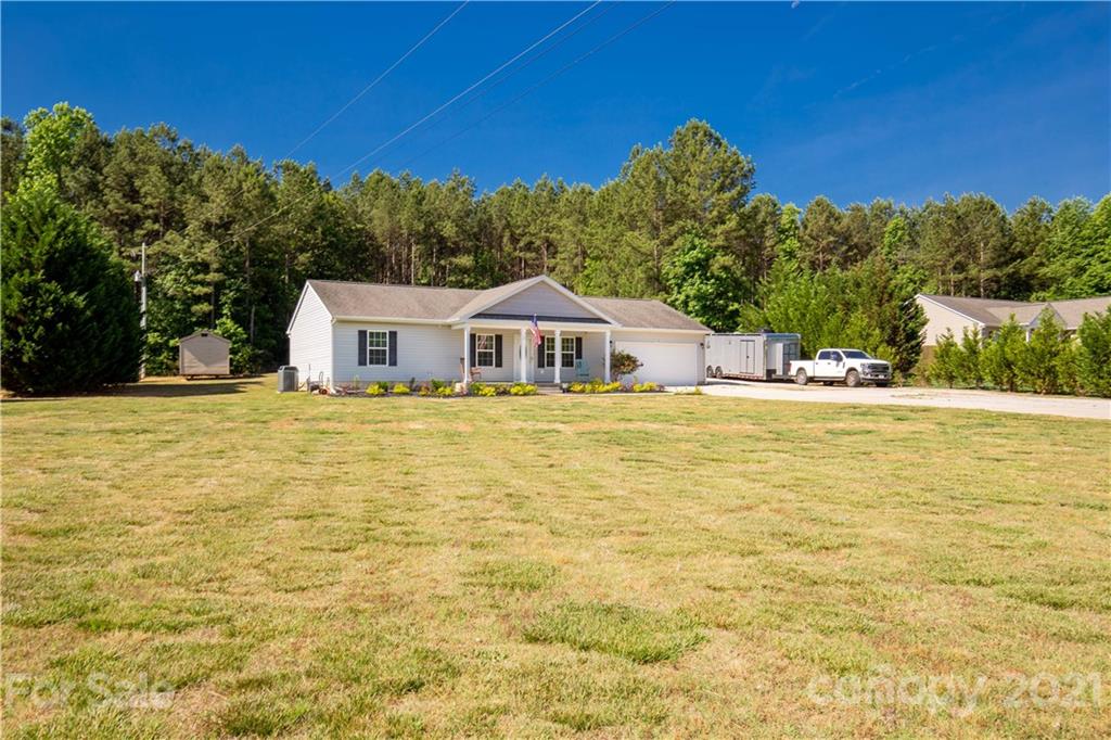 5150 Taxahaw Road Lancaster, SC 29720 - Photo 3 of 27 a house view with a swimming pool and garden