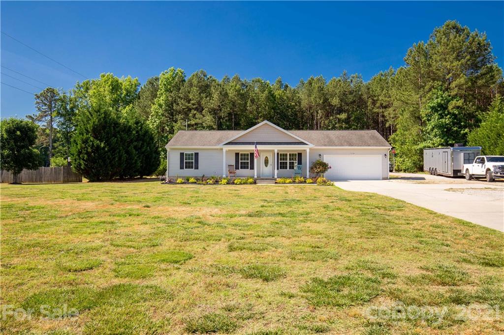 5150 Taxahaw Road Lancaster, SC 29720 - Photo 6 of 27 a house view with swimming pool and trees in the background