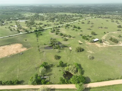 an aerial view of a houses with beach