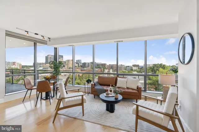 a living room with patio furniture and a floor to ceiling window